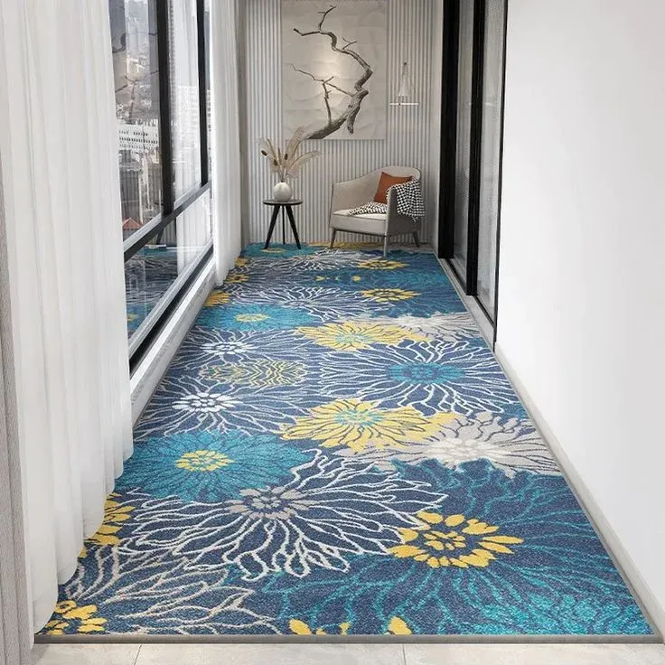 A long, wide hallway runner rug featuring a bold and vibrant large floral pattern in shades of blue, teal, yellow, and white.