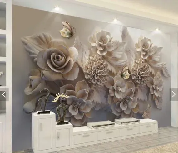 Large 3D effect floral removable wall mural featuring carved white and beige flowers with butterflies behind a low white TV console.